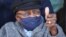 FILE - Archbishop Desmond Tutu gestures after receiving his coronavirus (COVID-19) vaccination in Cape Town, South Africa, May 17, 2021. 