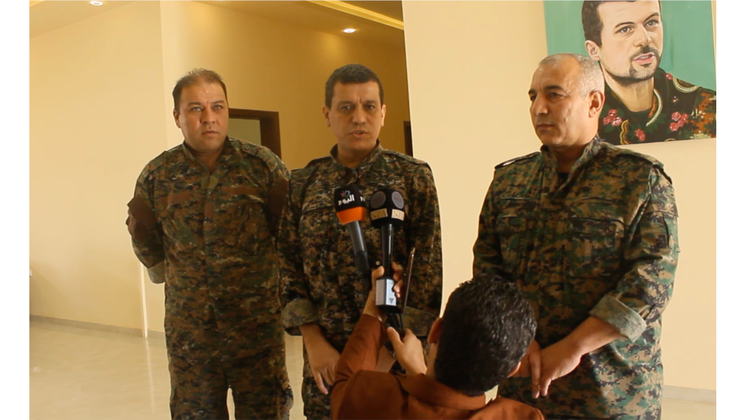 SDF general commander Mazloum Abdi, center, speaks during a press conference in Kobani, Syria, July 22, 2019. (S. Kajjo/VOA video grab)
