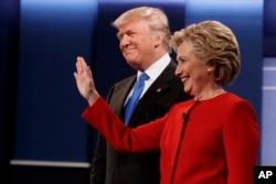 Republican presidential candidate Donald Trump, left, stands with Democratic presidential candidate Hillary Clinton before the first presidential debate at Hofstra University, Monday, Sept. 26, 2016, in Hempstead, N.Y.