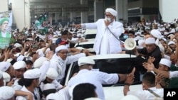 Ketua Front Pembela Islam (FPI) Rizieq Shihab (tengah) berbicara di hadapan para pendukungnya setelah tiba di Tanah Air dari Arab Saudi, di Bandara Soekarno-Hatta, Tangerang, Selasa, 10 November 2020. (Foto: AP)