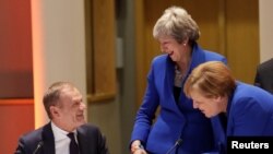 German Chancellor Angela Merkel, Britain's Prime Minister Theresa May and European Council President Donald Tusk attend an extraordinary European Union leaders summit to discuss Brexit, in Brussels, Belgium, April 10, 2019. 