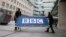 FILE - BBC workers place barriers near to the main entrance of the BBC headquarters and studios in Portland Place, London, July 16, 2015. Britain stepped back from cutting the size and scope of the BBC on May 12, 2016, after the publicly-funded broadcaster and some of its biggest stars had accused ministers of threatening the independence of the 94-year-old institution.