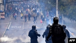 Demonstrators clash with the riot police around the national assembly in Quito on October 8, 2019.
