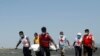 Members of the Myanmar Red Cross carry a dead body of a driver from a boat in Sittwe, Rakhine State 