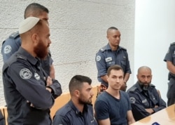 ISRAEL -- Russian citizen Aleksei Burkov (2nd R seated), suspected of hacking-related crimes, attends court a hearing in Jerusalem, November 3, 2019