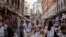 FILE -Tourists walk in a crowded street in Venice, Italy, on Sept. 13, 2023. Venice on Dec. 30 announced new limits on the size of tourist groups in a measure aimed at reducing the pressure of mass tourism on the famed canal city.