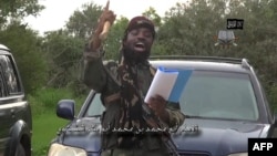 FILE - Video screen shot of Nigerian Islamist extremist group Boko Haram leader Abubakar Shekau delivering a speech at an undisclosed location, Aug. 24, 2014.
