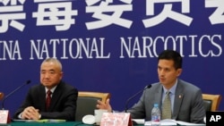 U.S. Drug Enforcement Administration's representative in Beijing, Lance Ho, right, speaks next to Wei Xiaojun, deputy director-general of the Narcotics Control Bureau of the Ministry of Public Security during a press conference in Beijing, Nov. 3, 2017.