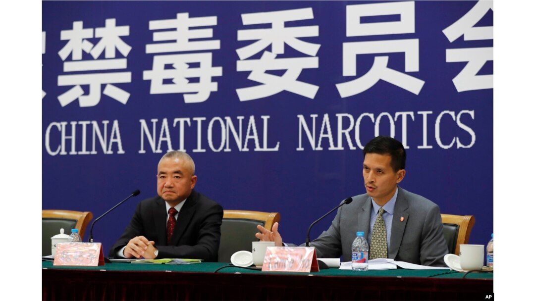 U.S. Drug Enforcement Administration's representative in Beijing, Lance Ho, right, speaks next to Wei Xiaojun, deputy director-general of the Narcotics Control Bureau of the Ministry of Public Security during a press conference in Beijing, Nov. 3, 2017.