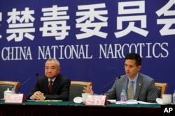 U.S. Drug Enforcement Administration's representative in Beijing, Lance Ho, right, speaks next to Wei Xiaojun, deputy director-general of the Narcotics Control Bureau of the Ministry of Public Security during a press conference in Beijing, Nov. 3, 2017.