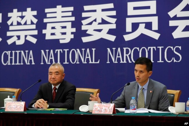 U.S. Drug Enforcement Administration's representative in Beijing, Lance Ho, right, speaks next to Wei Xiaojun, deputy director-general of the Narcotics Control Bureau of the Ministry of Public Security during a press conference in Beijing, Nov. 3, 2017.