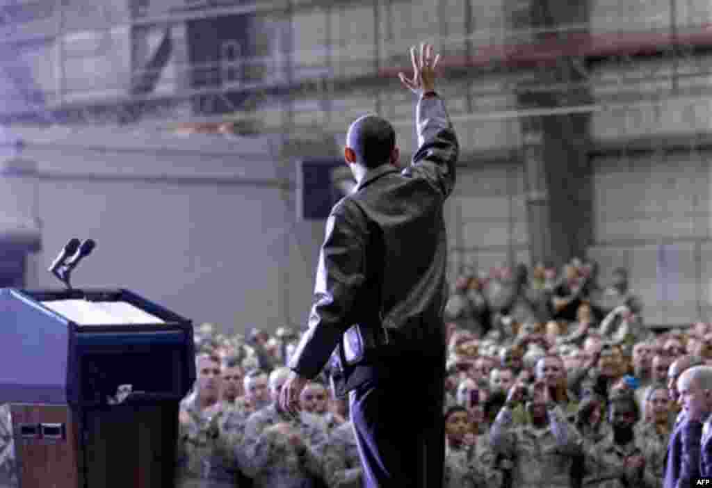President Barack Obama waves to troops at a rally during an unannounced visit at Bagram Air Field in Afghanistan, Friday, Dec. 3, 2010. (AP Photo/Pablo Martinez Monsivais)