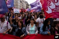 In Paris, demonstrators protest against new French Prime Minister Michel Barnier and the government, Sept. 21, 2024.