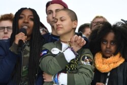 FILE - Marjory Stoneman Douglas High School student Emma Gonzalez, center, listens with other students during the March for Our Lives Rally in Washington, March 24, 2018.