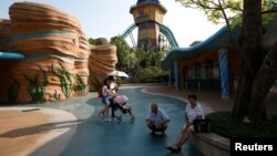 Visitors rest outside Chimelong Ocean Kingdom at Hengqin Island adjacent to Macau, China, Sept. 13, 2017. 