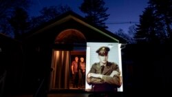 Images of veterans died from covid-19 projected onto their relatives' homes