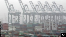 The Maersk cargo terminal, where container-handling cranes are in the up and idle position, is seen at the Port of Los Angeles, Nov. 29, 2012. Cargo ships were stacking up at the ports of Los Angeles and Long Beach as a strike by about about 70 clerical workers shut down most terminals that together are the nation's busiest port complex.