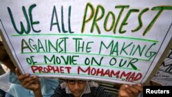 A Muslim youth holds up a placard during a protest against against the anti-Islam film, in Jammu, India Sept. 21, 2012.