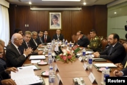 FILE - Afghan Foreign Minister Salahuddin Rabbani, right, talks with Pakistan's National Security Adviser Sartaj Aziz, left, during their meeting in Islamabad, Pakistan, August 13, 2015.