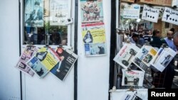 FILE - Newspapers and magazines are seen on a display in a kiosk in the center of Tehran, Iran.