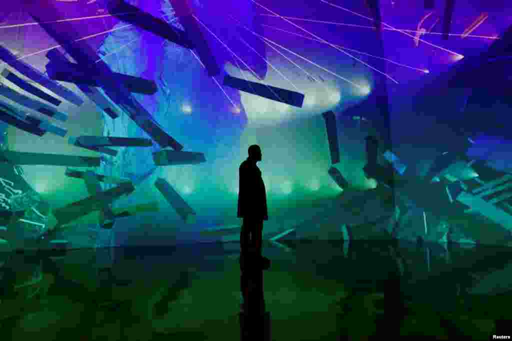 A man stands in front of a &#39;Lucid Motion&#39; exhibition at Artechouse in Washington, Nov. 17, 2019.