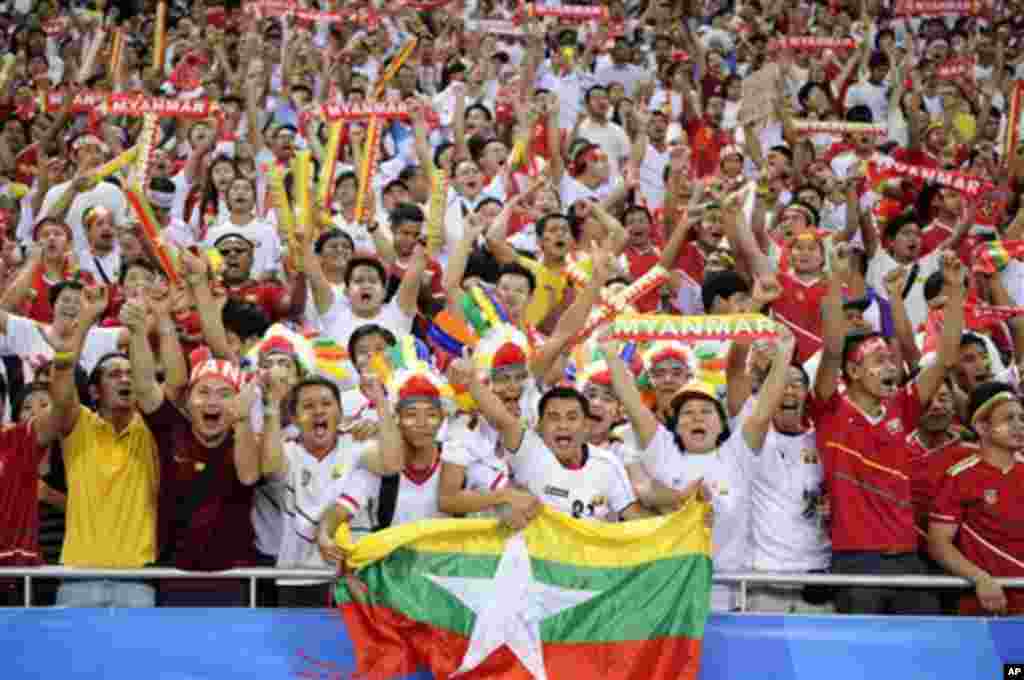 A Myanmar fans cheer ahead of the soccer final between Myanmar and Thailand at the SEA Games in Singapore, Monday, June 15, 2015. (AP Photo/Joseph Nair)