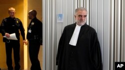 FILE - Luis Moreno-Ocampo leaves after a swearing-in ceremony at The International Criminal Court (ICC) in The Hague, Netherlands, Friday, June 15, 2012.