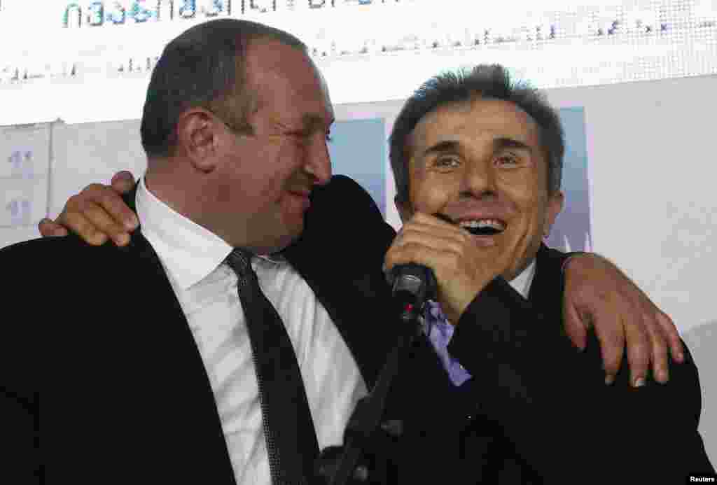 Georgia's Prime Minister Bidzina Ivanishvili and presidential candidate Georgy Margvelashvili celebrate after Sunday's election, Tbilisi, Oct. 27, 2013.