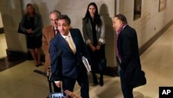 Michael Cohen, President Donald Trump's former lawyer, speaks briefly to the media as he leaves a closed-door hearing of the House Intelligence Committee accompanied by his lawyer, Michael Monico, Feb. 28, 2019, on Capitol Hill in Washington. 