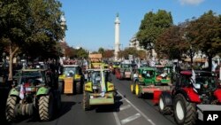 Angry farmers drive their tractors as they arrive in Paris, Sept. 3, 2015. 