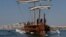FILE - Visitors row the Olympias, a replica of an ancient galley, at Saronic gulf in southern Athens. 