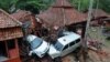 Bangunan-bangunan dan mobil-mobil yang rusak di Anyer, Serang, Minggu, 23 Desember 2018, setelah kawasan itu dilanda tsunami akibat letusan Gunung Anak Krakatau pada Sabtu, 22 Desember 2018. (Foto: AFP)