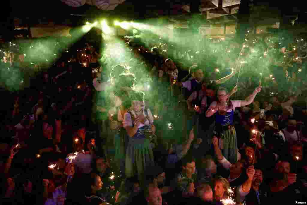 Oktoberfest waitstaff celebrate the end of the world’s biggest beer festival, the 189th Oktoberfest, in Munich, Germany, Oct. 6, 2024.