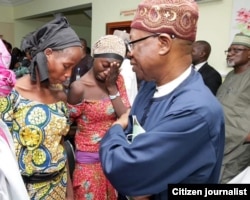 FILE - Nigerian Vice President Yemi Osinbajo and other officials meet with the 21 Chibok girls released by Boko Haram militants at the DSS Hospital in Abuja, Oct. 13, 2016.