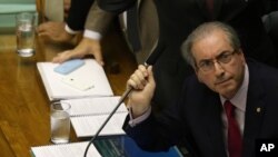 FILE - Brazil's House Speaker Eduardo Cunha watches results come in on a screen, after a vote to nominate representatives for a special commission that will determine whether impeachment proceedings against President Dilma Rousseff will go to a full vote 