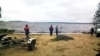 In this Russian Emergency Situations Ministry photo, made available on Sunday, June 19, 2016, Russian Ministry for Emergency Situations workers stand at the site of an incident, at a lake in Russia's northwestern region of Karelia, Russia.