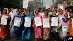 Activists of Trinamool Congress party hold banners and shout slogan during a protest march against the government's decision to withdraw high denomination notes from circulation, in Kolkata, India, Nov. 28, 2016. 