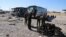 Iraqi security forces inspect the site of a blast where a suicide bomber detonated his explosives-laden ambulance in Iraq's holy city of Samarra, north of Baghdad, Nov. 6, 2016. 
