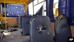 A photo provided by the Ukrainian Interior Ministry shows the inside of a bus destroyed by a shell at the checkpoint near the town of Volnovakha in Donetsk, eastern Ukraine, Jan. 13, 2015.