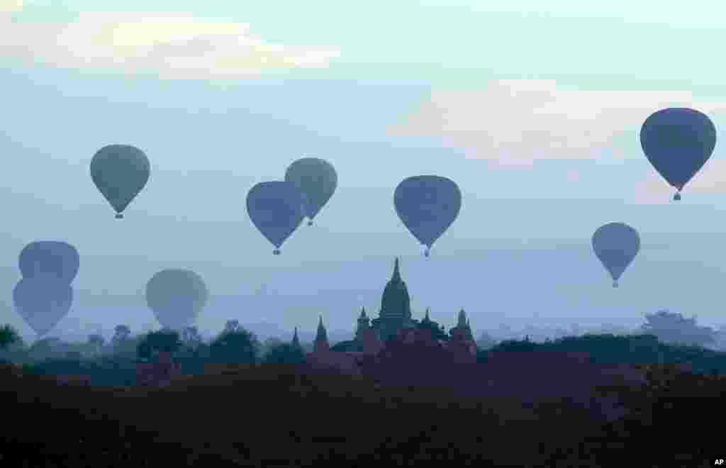 Hot air balloons fly over the Myanmar's old temple just before sunrise in Bagan, Nyaung U district, central Myanmar, Dec. 16, 2018. 