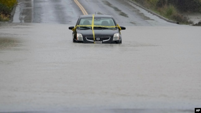 A car is left stranded on a flooded road during a storm Nov. 21, 2024, in Windsor, Calif.