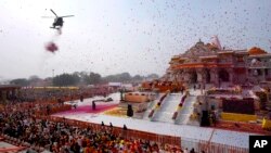 An Indian Air Force helicopter showers flower petals during the opening of a temple dedicated to Hinduism's Lord Ram in Ayodhya, India, on Jan. 22, 2024. Indian Prime Minister Narendra Modi opened the controversial Hindu temple, which is built on the ruins of a historic mosque.