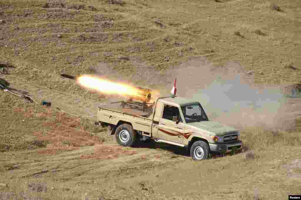 A vehicle belonging to Kurdish security forces fires a multiple rocket launcher during clashes with the Islamic State of Iraq and the Levant on the outskirts of Diyala, Iraq, June 14, 2014.