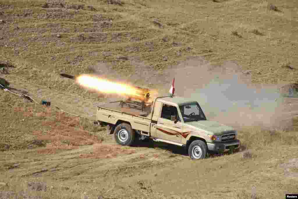 A vehicle belonging to Kurdish security forces fires a multiple rocket launcher during clashes with the Islamic State of Iraq and the Levant on the outskirts of Diyala, Iraq, June 14, 2014. 