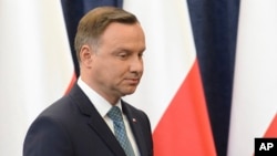 FILE - Polish President Andrzej Duda prepares to make a statement in Warsaw, Poland, July 24, 2017.