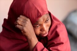 FILE - The mother of Muhammad Bello, one the students who was abducted by gunmen, reacts in Kankara, in northwestern Katsina state, Nigeria, De. 14, 2020.