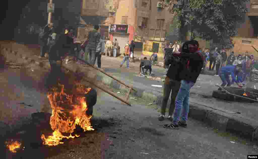 Supporters of the Muslim Brotherhood and ousted Egyptian President Mohamed Morsi close the road during clashes with riot police in Cairo, Jan. 25, 2014.