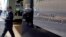 FILE - A man walks out of the 666 Fifth Avenue office tower owned by the Kushner Cos., the real estate company run by the family of Jared Kushner. in New York, March 29, 2017.