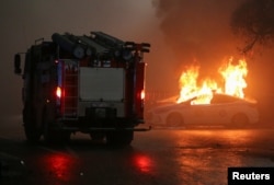 A police car burns during a protest in Almaty, Kazakhstan, Jan. 5, 2022.