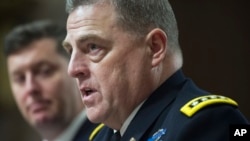 Army Undersecretary Patrick Murphy listens at left as Army Chief of Staff Gen. Mark Milley testifies on Capitol Hill in Washington at a Senate hearing to examine the implementation of the decision to open all ground combat units to women, Feb. 2, 2016.